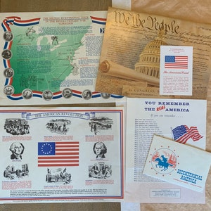 May include: A set of four educational posters about the American Revolution. The posters feature maps, illustrations, and text about the Revolutionary War. The posters are printed on white paper with red, white, and blue accents.