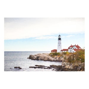 May include: A white lighthouse with a black roof stands on a rocky cliff overlooking a blue ocean. The lighthouse is surrounded by green foliage and a small red-roofed building.