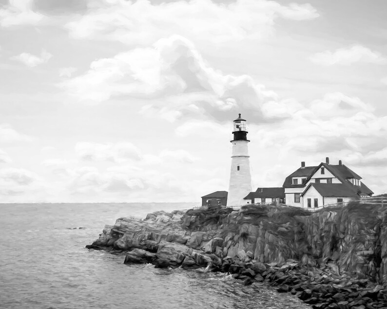 May include: A black and white photograph of a lighthouse on a rocky cliff overlooking the ocean. The lighthouse is tall and white with a black top. The sky is cloudy and the water is choppy.