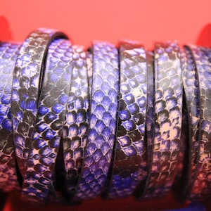 May include: A spool of black and purple leather cord with a snakeskin pattern.