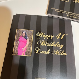May include: Black and gold striped card with a photo of a woman in a pink dress. The card says "Happy 41st Birthday Leah Miles" and has the website upanotchgifts.etsy.com at the bottom.