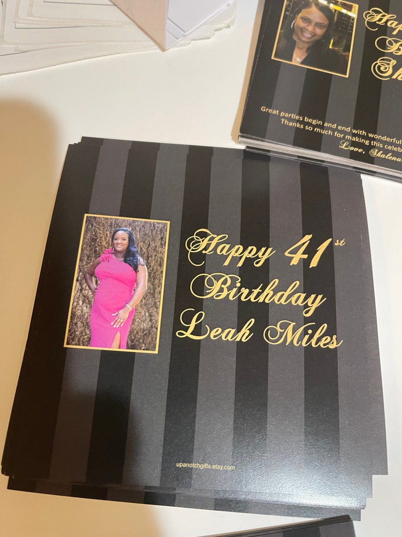May include: Black and gold striped card with a photo of a woman in a pink dress. The card says "Happy 41st Birthday Leah Miles" and has the website upanotchgifts.etsy.com at the bottom.