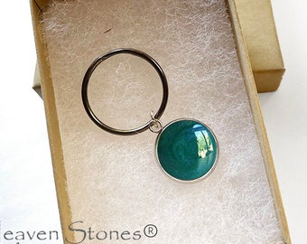 May include: A 16mm stainless steel dog tag with a green enamel circle and a silver ring. The tag is in a white box with the text "Heaven Stones® from MEMORIAL SILVER".