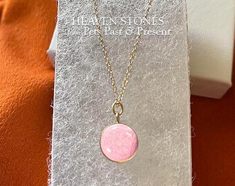 May include: A 14K solid gold necklace featuring a 10mm round light pink pendant. The text HEAVEN STONES from Pets Past & Present is visible. The pendant is suspended on a thin gold chain, presented on a silver textured display card.