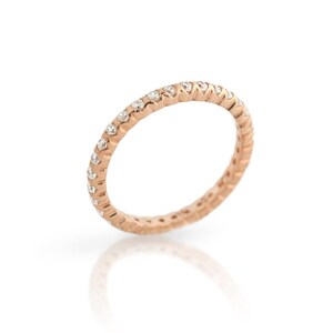 May include: A rose gold eternity ring with a continuous row of small, clear gemstones. The ring is set against a white background, with a subtle reflection visible below.