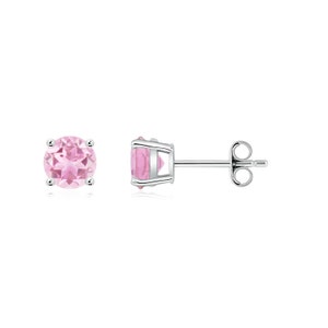 May include: A pair of silver stud earrings with pink round gemstones.