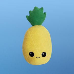 May include: A plush pineapple toy with a smiling face, black eyes, and rosy cheeks. The pineapple is yellow with green leaves on top. The toy is designed with a cute, cartoonish style.