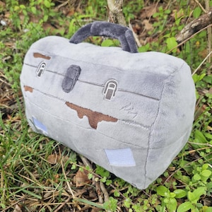 May include: A set of three ceramic mugs with a speckled, matte finish. The mugs are in shades of cream, light gray, and dark gray. Each mug has a simple, minimalist design, perfect for coffee or tea.