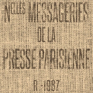 May include: A close-up of a brown hessian sack with the text "Messageries de la Presse Parisienne" and "R-1907" printed on it.