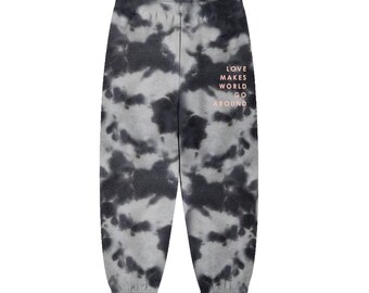 May include: Gray sweatpants with a tie-dye pattern. The sweatpants have a pink message that reads "Love makes the world go around."