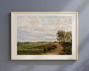 May include: A framed landscape painting depicting a rural scene with a dirt road winding through green fields and trees. The sky is filled with fluffy white clouds. The artwork is in a light wooden frame.