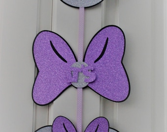 May include: Purple and silver glitter Minnie Mouse head door hanger with the words "Come Inside", "It's", and "Fun Inside".