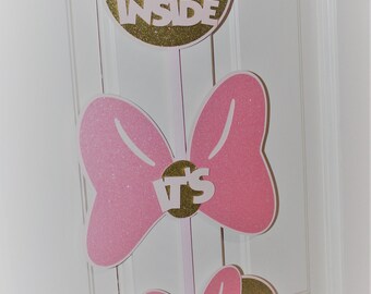 May include: Three gold glitter Minnie Mouse head cutouts with pink bows and white text. The top cutout says "Come Inside", the middle cutout says "It's", and the bottom cutout says "Fun Inside".