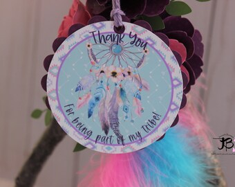 May include: A round, purple and white thank you tag with a turquoise background. The tag features a dreamcatcher with feathers and the text "Thank You for being part of my tribe!"