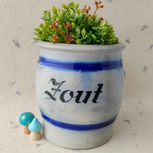 May include: A set of three ceramic mugs with a speckled, matte finish. The mugs are in shades of cream, light gray, and dark gray. Each mug has a simple, minimalist design, perfect for coffee or tea.