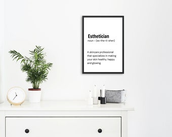 May include: Black and white framed print with the definition of the word "Esthetician" in a minimalist style. The definition reads: "A skincare professional that specializes in making your skin healthy, happy and glowing."
