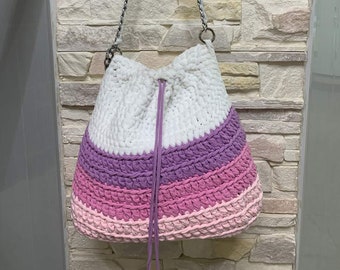 A woman's bag of knitted yarn.