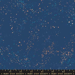 May include: Dark navy fabric featuring a speckled design in peach, teal, and light blue. The fabric has a dark blue backdrop with a scattered pattern, creating a celestial or abstract effect. The text "RUBY STAR SOCIETY" is at the bottom.