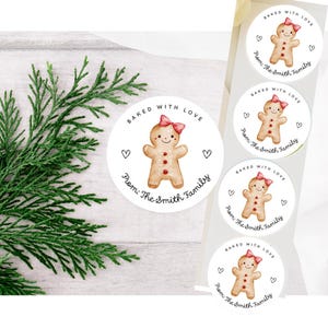 May include: Round stickers with a watercolor gingerbread man design. Each sticker has the text "Baked with Love" and "From: The Smith Family". The gingerbread man has a pink bow and heart accents.