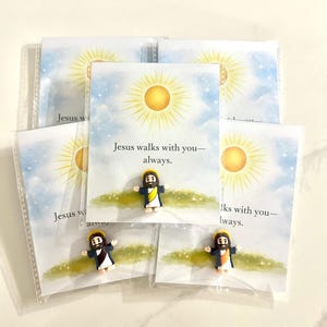 May include: A set of three ceramic mugs with a speckled, matte finish. The mugs are in shades of cream, light gray, and dark gray. Each mug has a simple, minimalist design and a rounded handle.