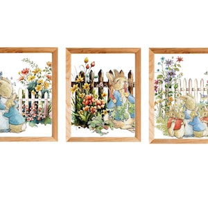 May include: Three framed watercolor paintings of rabbits in a garden setting. The first painting shows a mother rabbit hugging a baby rabbit. The second painting shows a rabbit eating a carrot. The third painting shows a mother rabbit with two baby rabbits.