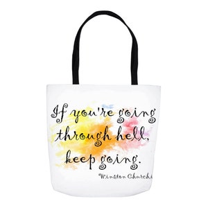 May include: White tote bag with black handles featuring a watercolor background with a quote in black script: "If you're going through hell, keep going."  The quote is attributed to Winston Churchill.
