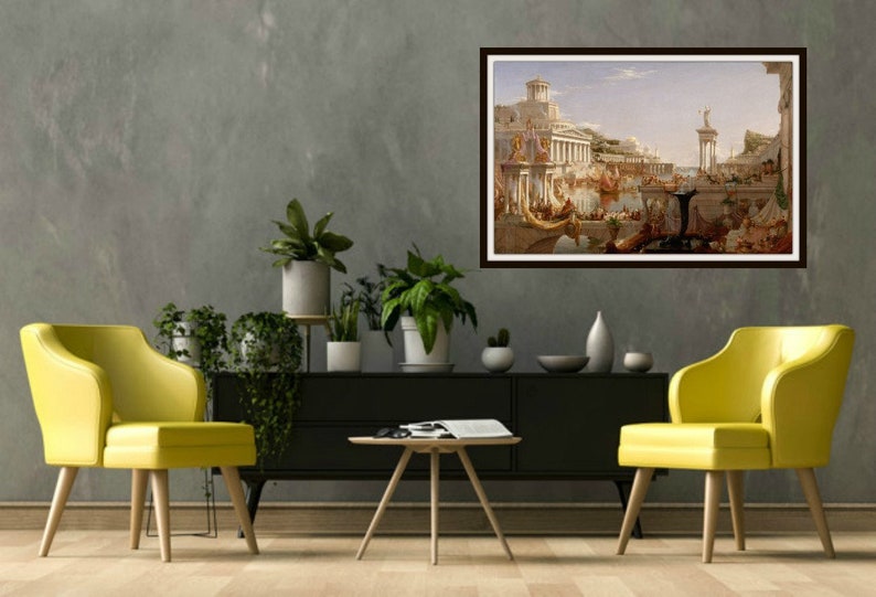 May include: A framed painting of a city scene with a large building in the center and many people in the foreground. The painting is in a brown frame and is hanging on a gray wall.
