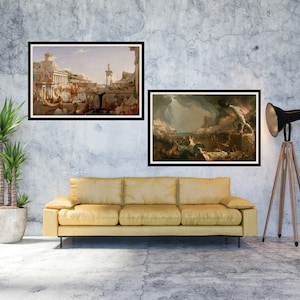 May include: Two framed paintings of historical scenes hang on a gray concrete wall above a yellow couch. The painting on the left depicts a bustling city scene with people and buildings. The painting on the right shows a dramatic scene of a city on fire with smoke and flames.