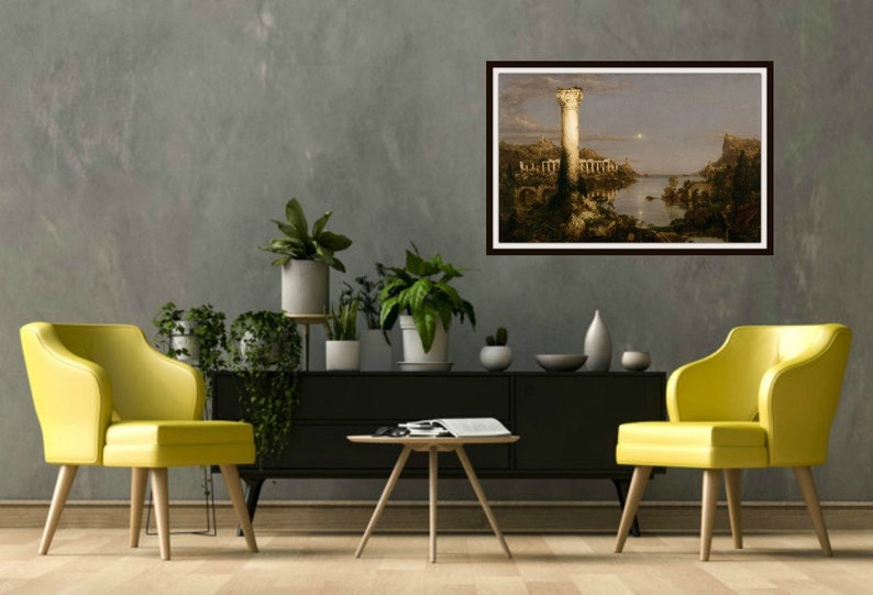 May include: A framed painting of a landscape with a tall tower in the center. The tower is lit by a bright light, and the rest of the landscape is bathed in a soft, golden light. The painting is set against a gray wall, and there are two yellow chairs and a coffee table in the foreground.
