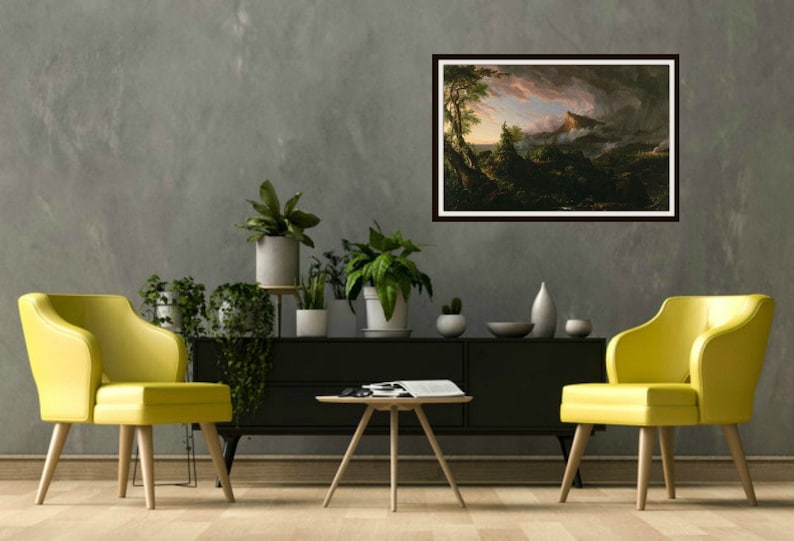 May include: A framed painting of a landscape with a mountain in the background and trees in the foreground. The sky is cloudy and there is a hint of pink in the clouds. The painting is hanging on a gray wall in a living room setting.