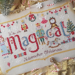 May include: Cross stitch pattern featuring a Nutcracker Christmas theme. The design includes the words "It's a magical Nutcracker Christmas" with a variety of festive imagery, including a Nutcracker, a Christmas tree, and a rocking horse.