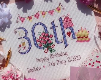 Puede incluir: Un diseño de punto de cruz blanco con acentos azules y rosas. El diseño presenta el número 30, un ramo de rosas, un pastel de cumpleaños y una pancarta. El texto "Happy Birthday Tabitha 7th May 2020" está incluido.