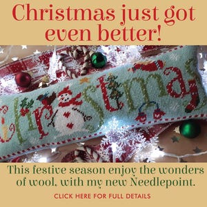 May include: A festive needlepoint cushion featuring the word "Christmas" in red and green on a light blue base. The design includes a snowman, a Christmas tree, and other seasonal motifs. The text "Christmas just got even better!" is at the top.