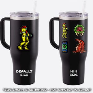 May include: Black insulated tumblers with handles, lids, and straws. One tumbler features a pixelated yellow character, the other has multiple pixelated images. Text on the tumblers reads "DEFAULT SIZE" and "MINI SIZE".