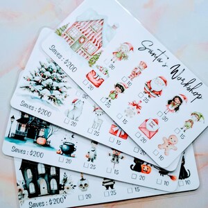 May include: A stack of four white cards with watercolor illustrations and the text "Santa's Workshop." Each card features a different theme: Christmas, Halloween, and a winter scene. Each card has a "Saves: $200" label.