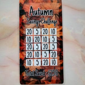 May include: A savings challenge card with a fall theme. The card has a grid of numbers, including 5, 10, and 20. The card also has the text "Autumn Savings Challenge" and "Total Saved: $250".