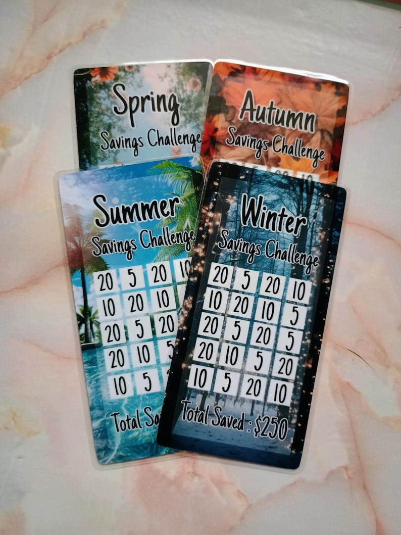 May include: Four colorful cards with a savings challenge theme. Each card features a different season: Spring, Summer, Autumn, and Winter. The cards have a grid of numbers, including 5, 10, and 20. The text "Total Saved: $250" is visible on the Winter card.