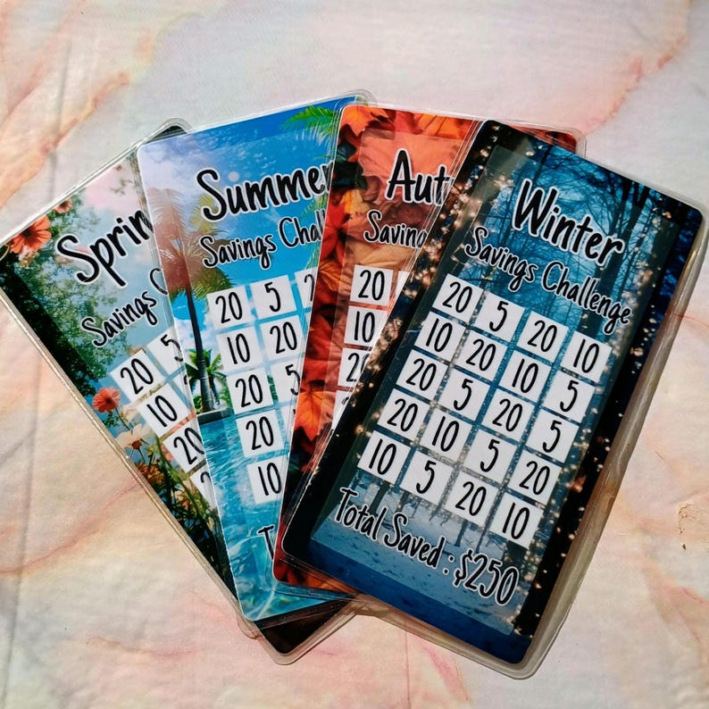 May include: Four colorful cards with a savings challenge theme. Each card features a different season: Spring, Summer, Autumn, and Winter. The cards have a grid with numbers 5, 10, and 20. The Winter card has the text "Total Saved: $250".