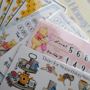 May include: A collection of Winnie the Pooh themed stickers and cards. The cards feature illustrations of Pooh and Piglet, along with text that reads "Time for Something Sweet" and "Honey". Some cards have numbers and honeycomb designs.