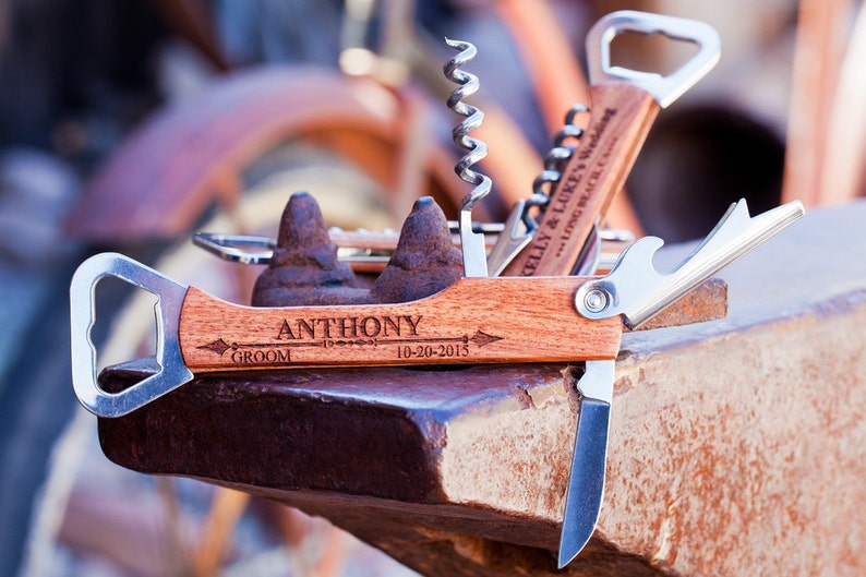 May include: A wooden multi-tool with a bottle opener, corkscrew, and knife. The tool is engraved with the name "ANTHONY" and the date "10-20-2015".