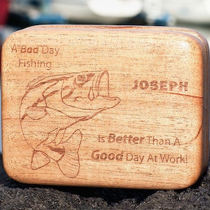 May include: A wooden box with a bass fish design and the text "A Bad Day Fishing Is Better Than A Good Day At Work!" and the name "Joseph" engraved on the front.