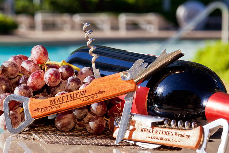 May include: A wooden bottle opener with a corkscrew and a bottle opener. The handle is engraved with the text "Matthew Best Man 10-20-2015".