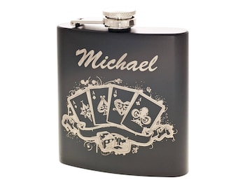 May include: Black metal flask with a silver lid and a personalized engraving that reads "Michael". The flask features a design of four playing cards with a ribbon and dice.