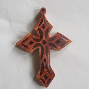 Wooden wall cross made out of rustic knotty cedar wood.
