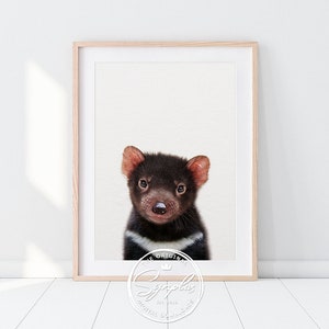 May include: A digital download print featuring a close-up portrait of a Tasmanian devil with black fur, white markings, and a pink nose. The image has a white background and a watermark in the bottom right corner that reads "The Original Sygoplus Est. 2015 Digital Downloads".