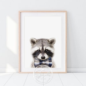 May include: A cute raccoon wearing a blue and white bow tie. The raccoon is looking directly at the camera. The background is white.