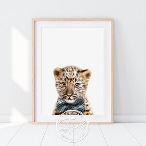 May include: A digital print of a leopard cub wearing a green and black plaid bow tie. The cub is looking directly at the viewer. The background is white.