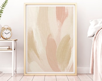 May include: Abstract art print in a gold frame with brushstrokes in shades of pink, beige, and brown. The print is hanging on a white wall in a bedroom setting.