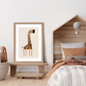 May include: A framed print of a cartoon giraffe with brown and black spots on a beige background. The giraffe is standing on a light brown wooden floor in a room with a wooden bed and a white wall.