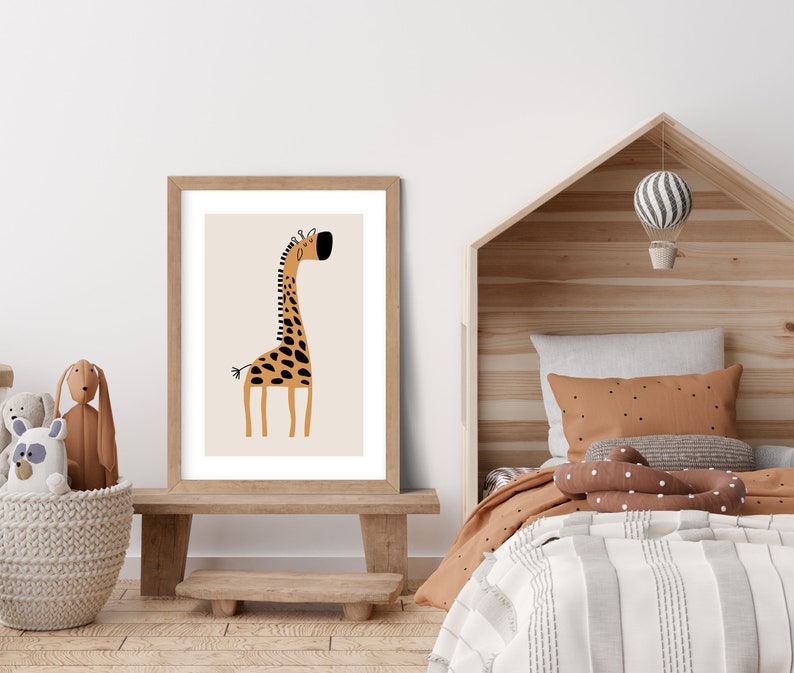 May include: A framed print of a cartoon giraffe with brown and black spots on a beige background. The giraffe is standing on a light brown wooden floor in a room with a wooden bed and a white wall.